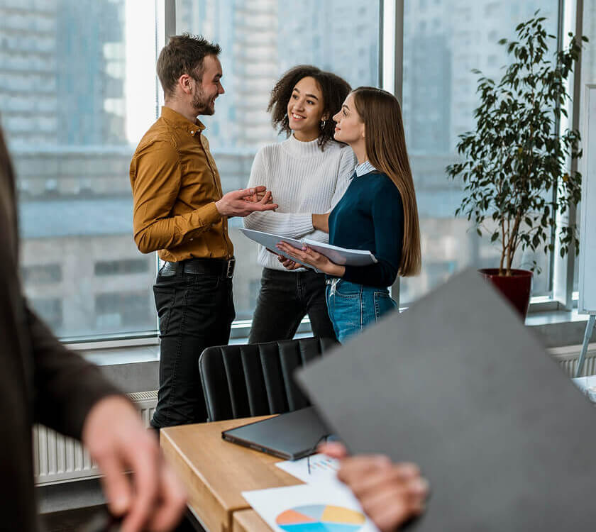 DMA Tech Solutions team members in conversation at the office