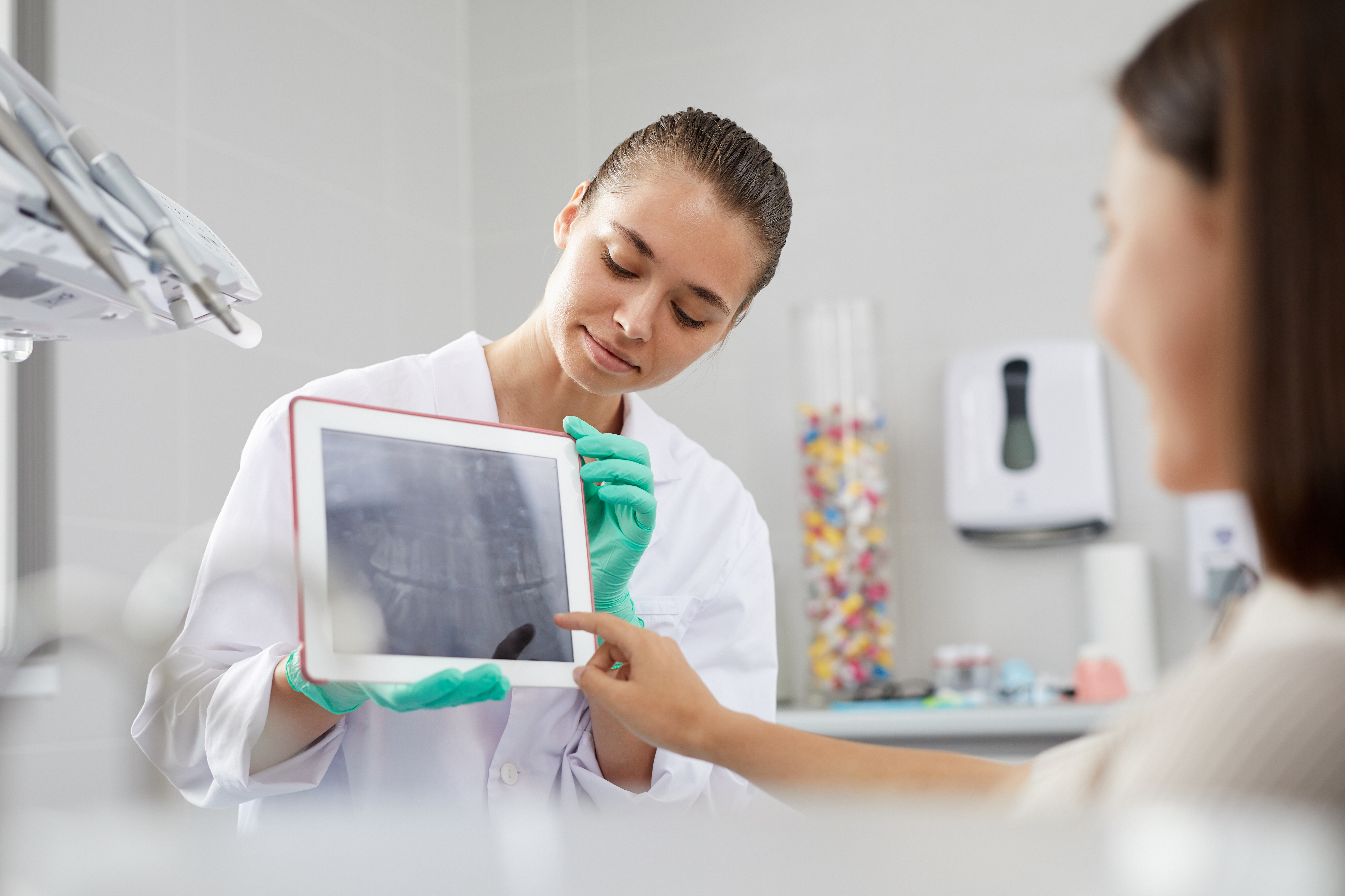 New Dental Technology Trends for 2022 - dentist shows x-ray on tablet